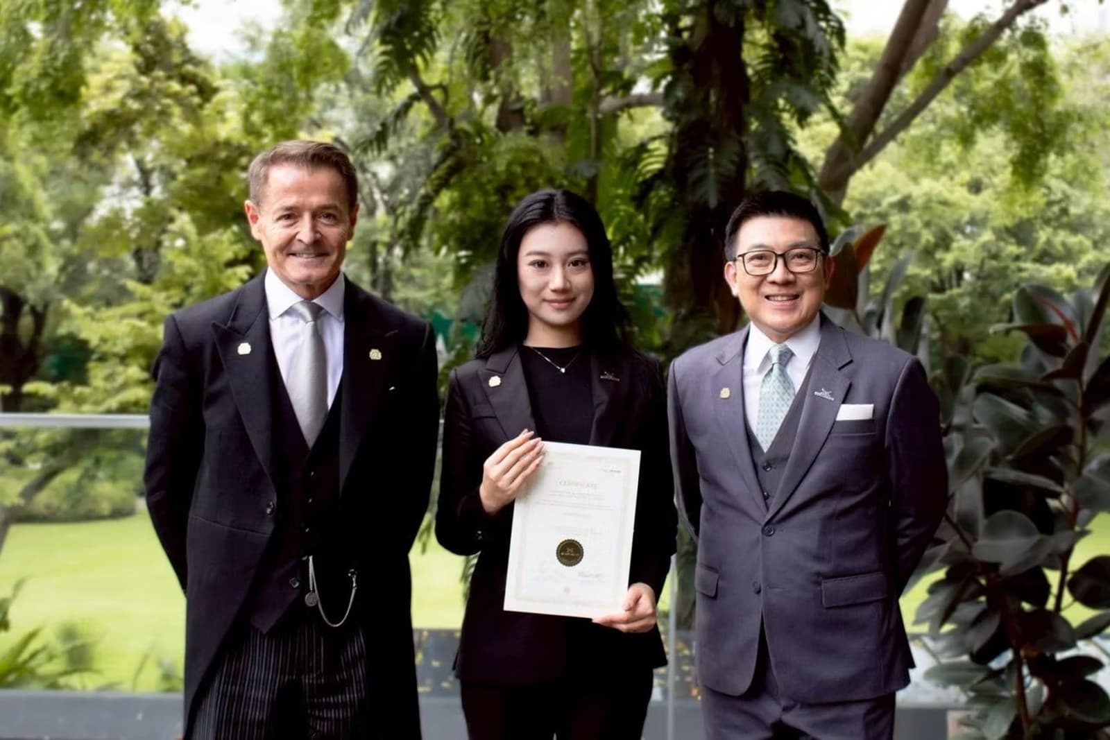 Tina Zhang receiving her certification from the British Butler Institute